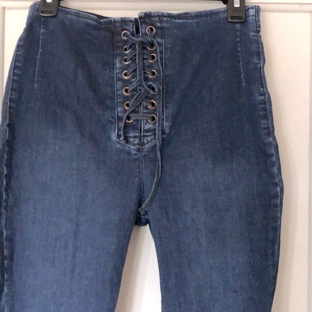 FP Free People. Size 30. High rise Grommet tie dark wash jeans. Skinny leg. EUC.